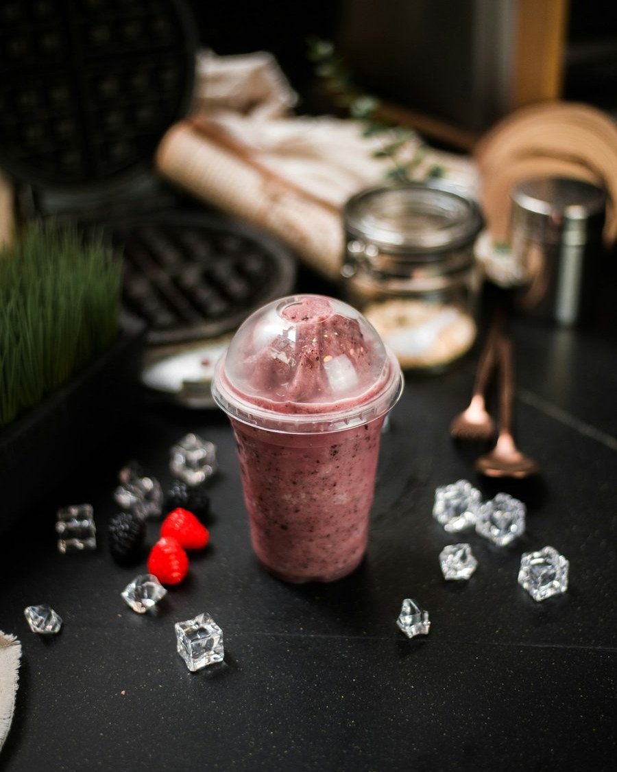 Berry smoothie in a to-go cup with ice